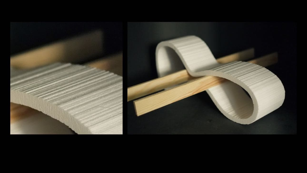 Two close-up photographs of the curved Linjen scale model