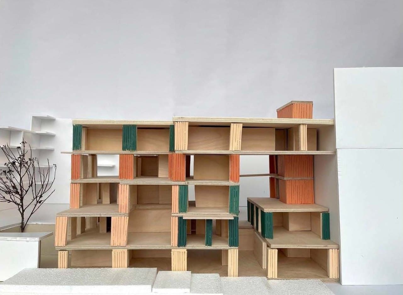 Street elevation of the 1:50 model of the Bodøgata building, with stacked apartments and ribbed facade panels in green and terracotta